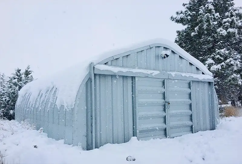 Metal workshop building in snow